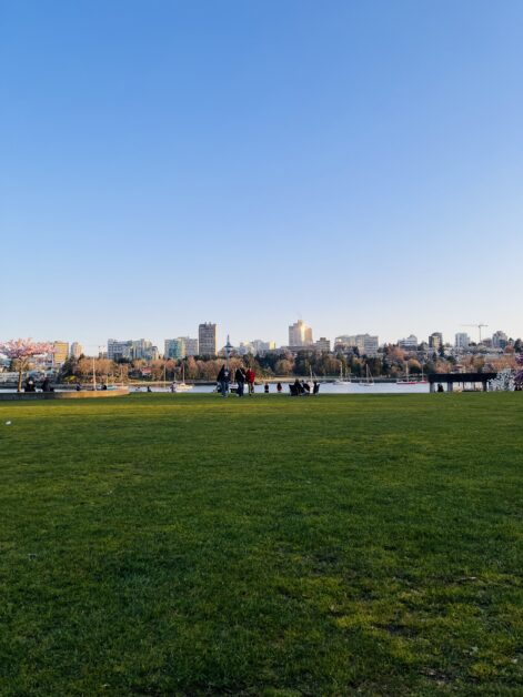 VanEcoRide E-bike riders at David Lam Park in Vancouver’s False Creek area with city skyline in the background