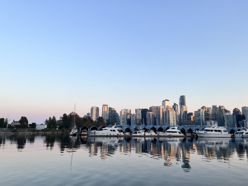 VanEcoRide E-bike riders on Stanley Park seawall path with forest and ocean views in Vancouver