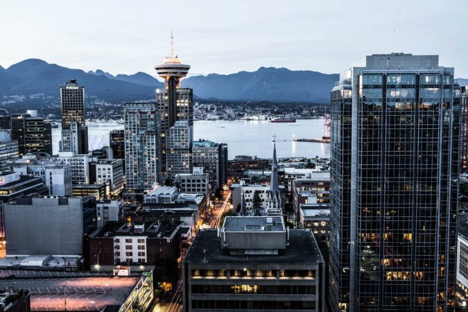 Downtown Vancouver skyline with waterfront and mountains in the background